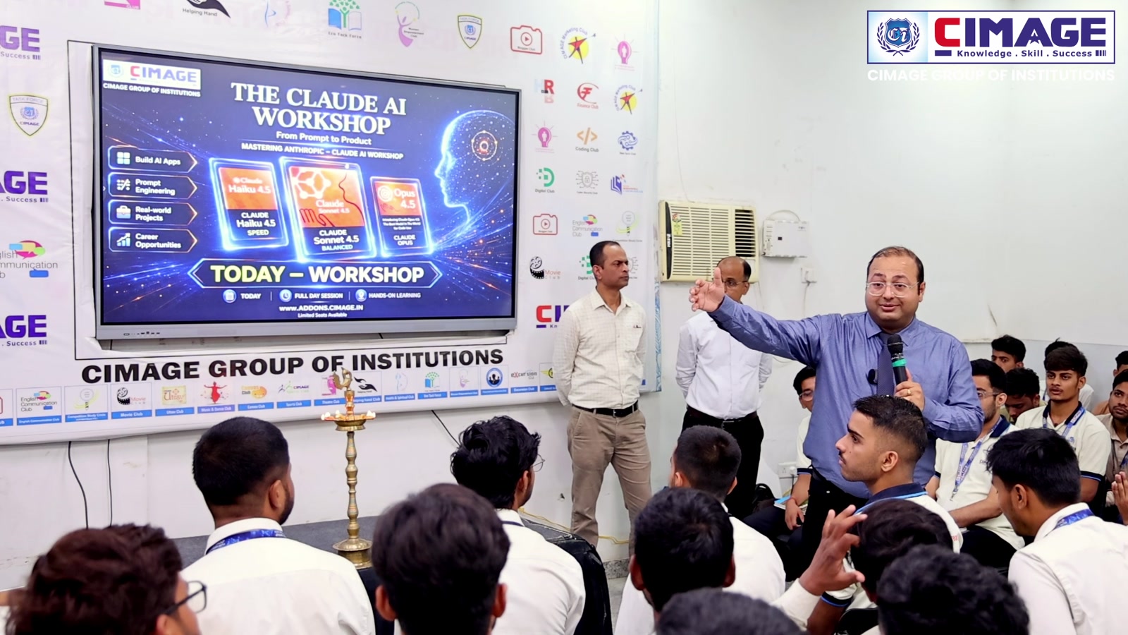 Speaker presenting during an educational workshop session with attentive students.